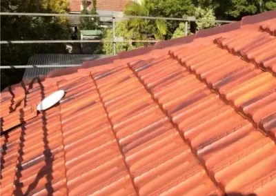 Tiled roof being cleaned to remove dirt and surface build-up