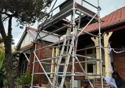 Roofing work being carried out on a tiled home with scaffolding
