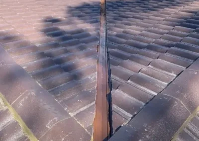 Restored tiled roof showing repaired valley and ridge areas