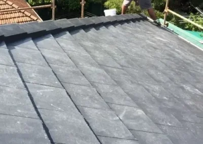 Roofer carrying out maintenance work on a flat roof surface