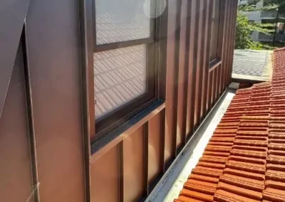 Close-up of metal wall cladding surrounding a window