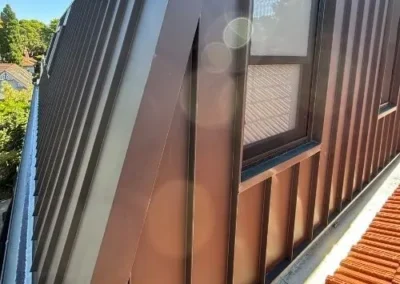 Vertical metal cladding installed around a residential window
