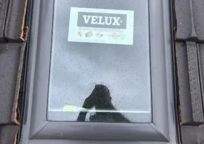 Velux skylight installed flush with a tiled roof