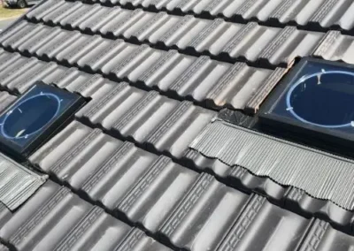 Roof windows and ventilation features installed on a tiled roof