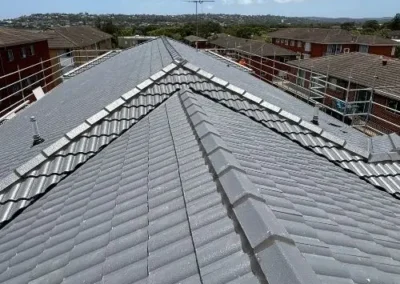 Completed restoration of a grey tiled residential roof