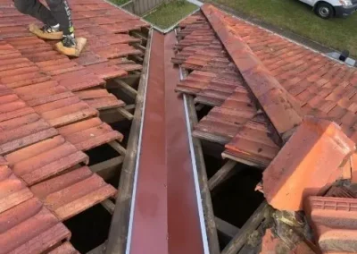 Replacement valley flashing installed on a terracotta tiled roof