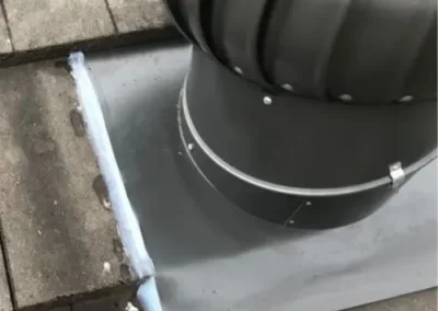 Roof ventilator installed on a light-coloured metal roof